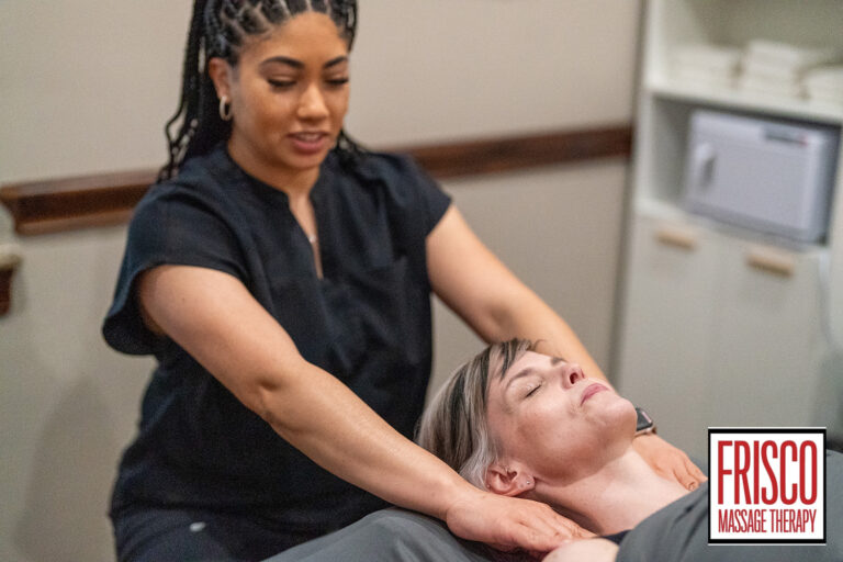 A massage therapist performs a neck and shoulder massage on a client lying on a table at Frisco Massage Therapy, also offering tips on how to prepare for manual lymphatic drainage before your session.