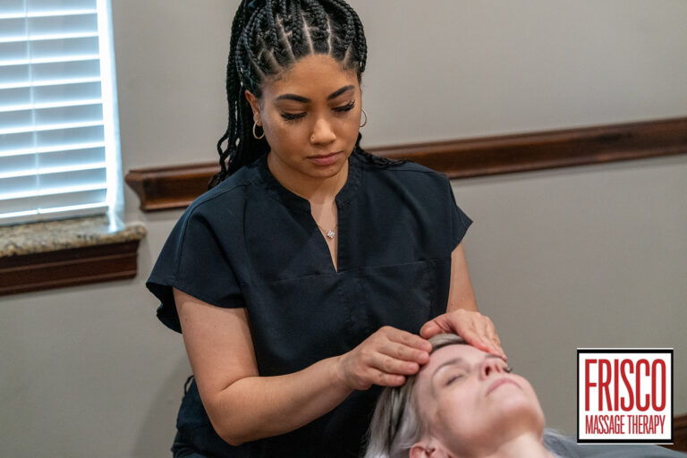 A massage therapist in black attire performs a head massage on a client lying down, showcasing how manual lymphatic drainage aids recovery. The "Frisco Massage Therapy" logo appears in the bottom right corner.