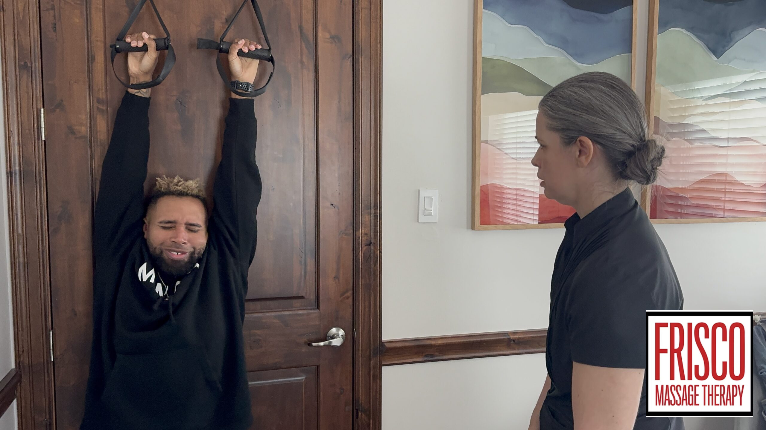 A person hangs from door-mounted straps while another person observes, suggesting techniques like cupping. The Frisco Massage Therapy logo is displayed in the lower right corner.
